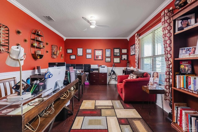 office with a ceiling fan, visible vents, crown molding, and dark wood-style floors