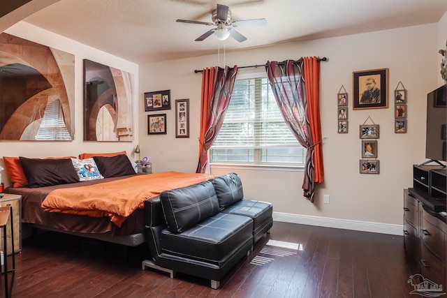 bedroom featuring ceiling fan, dark wood-type flooring, and baseboards