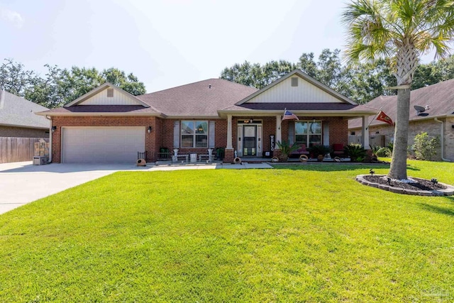 view of front facade with brick siding, an attached garage, a front yard, fence, and driveway