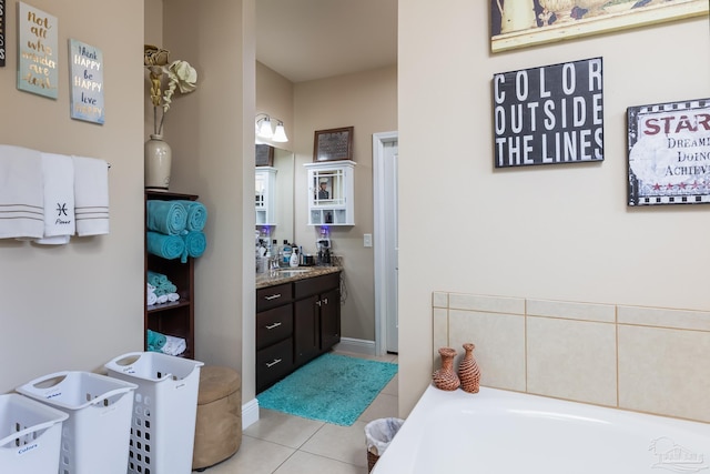 full bathroom featuring tile patterned flooring, a garden tub, and vanity