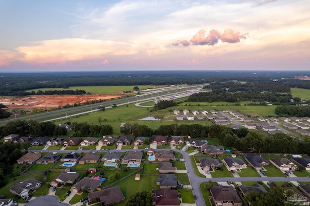 aerial view at dusk featuring a residential view