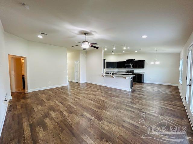 5643 Flume Dr, Pace, FL 32571 - unfurnished living room with dark wood finished floors, recessed lighting, baseboards, and a ceiling fan