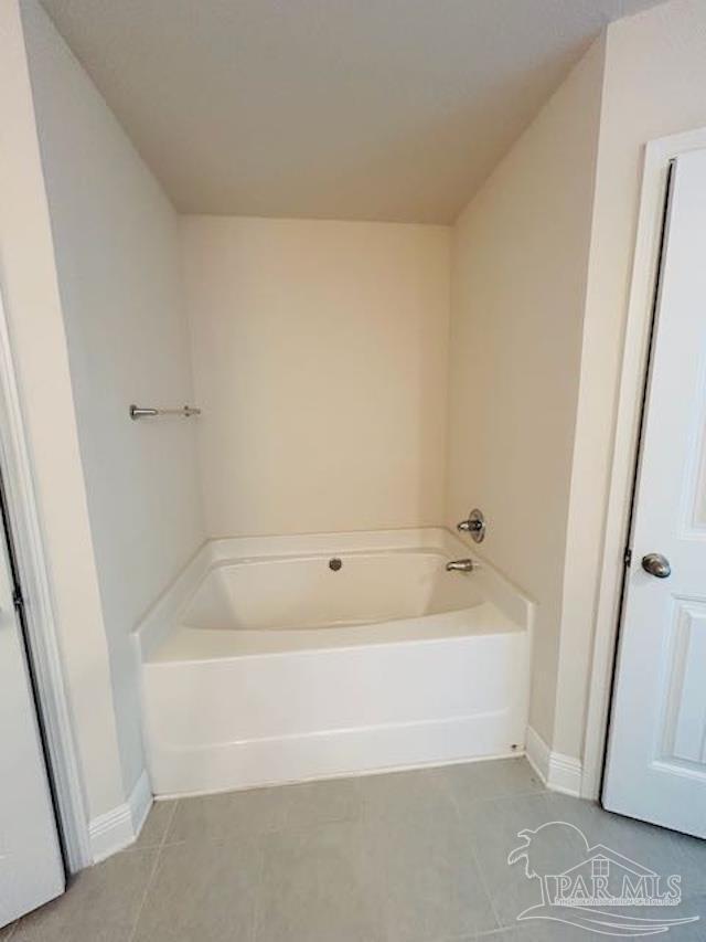 5643 Flume Dr, Pace, FL 32571 - full bath featuring tile patterned floors, a garden tub, and baseboards