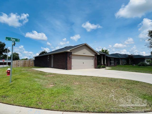 5643 Flume Dr, Pace, FL 32571 - view of front of home featuring a garage, driveway, and brick siding