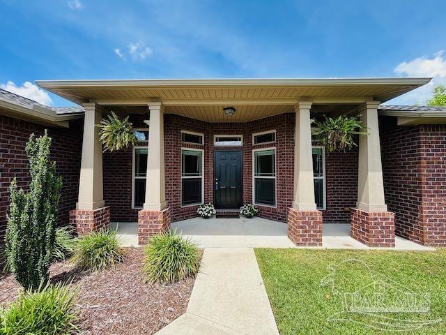 5643 Flume Dr, Pace, FL 32571 - entrance to property featuring brick siding and a porch