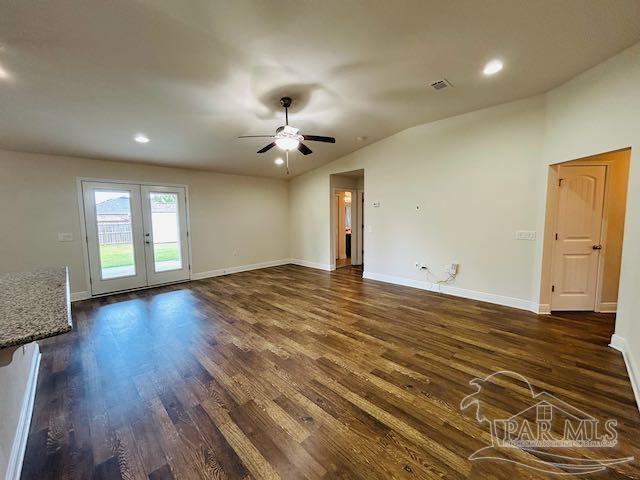 5643 Flume Dr, Pace, FL 32571 - unfurnished living room with lofted ceiling, dark wood-type flooring, ceiling fan, french doors, and baseboards