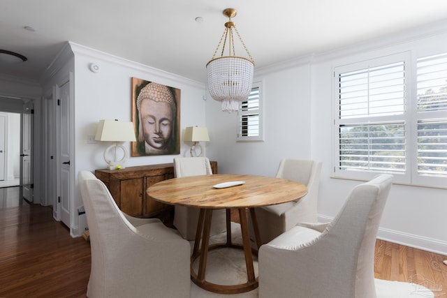 dining room with a chandelier, dark hardwood / wood-style flooring, and crown molding