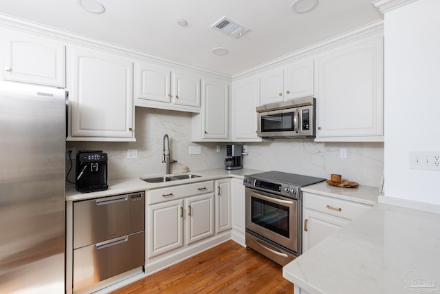 kitchen with sink, white cabinetry, and stainless steel appliances