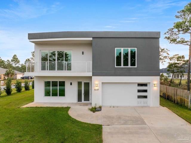 back of house with a yard, a balcony, and a garage