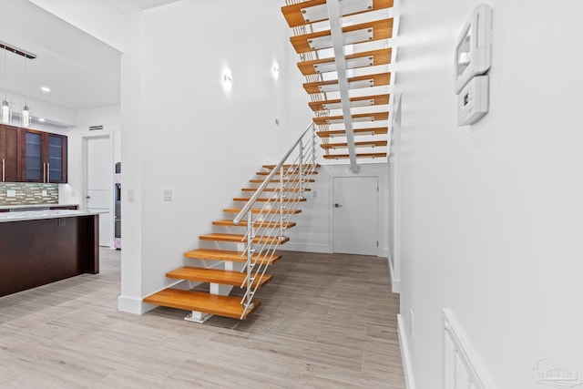 stairway featuring wood-type flooring