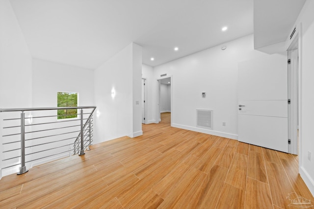 empty room with light hardwood / wood-style flooring