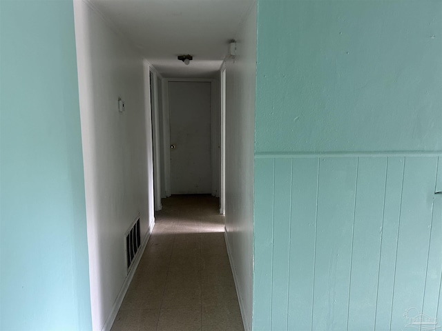 hall with visible vents and a wainscoted wall