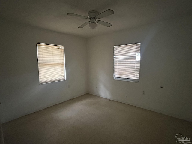 unfurnished room featuring ceiling fan and a healthy amount of sunlight