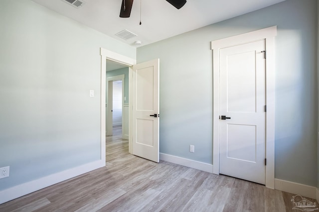 unfurnished bedroom with light wood-type flooring and ceiling fan