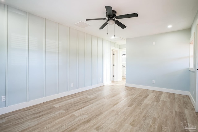 empty room featuring ceiling fan and light hardwood / wood-style flooring