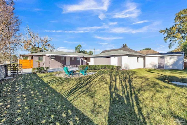 view of front of house featuring a front lawn and a patio area