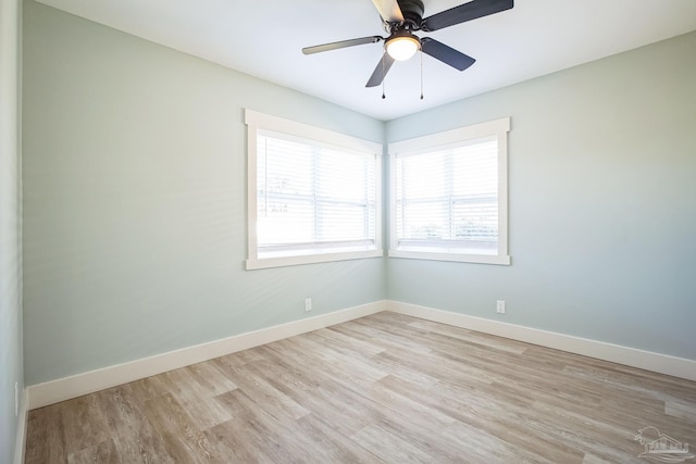 empty room with light hardwood / wood-style flooring and ceiling fan