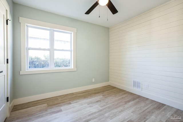 spare room featuring ceiling fan and light wood-type flooring