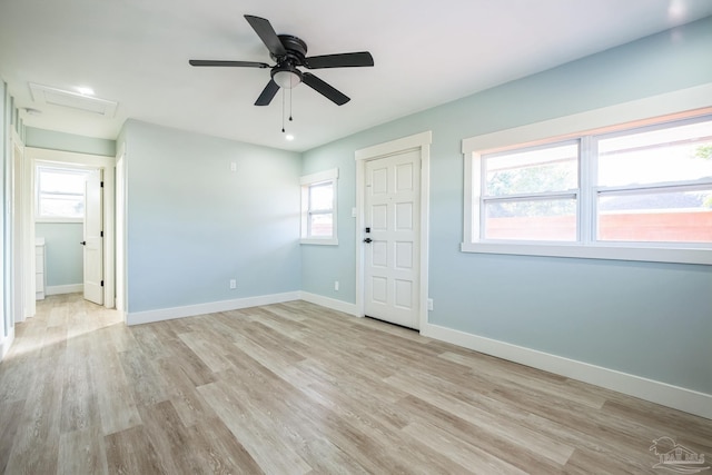 unfurnished bedroom with ceiling fan, light wood-type flooring, and multiple windows