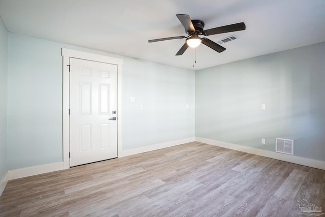 spare room featuring ceiling fan and light hardwood / wood-style floors