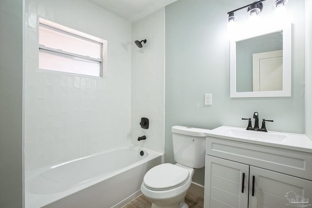 full bathroom featuring tiled shower / bath combo, toilet, wood-type flooring, and vanity