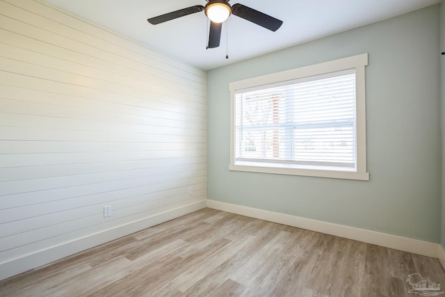 empty room featuring ceiling fan and light hardwood / wood-style flooring