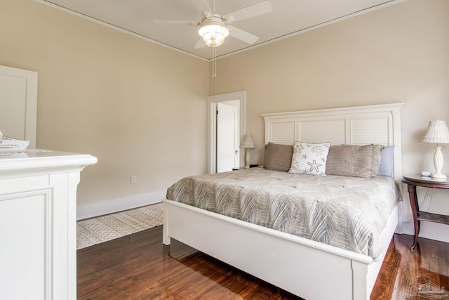 bedroom featuring dark wood-style floors, a ceiling fan, and baseboards