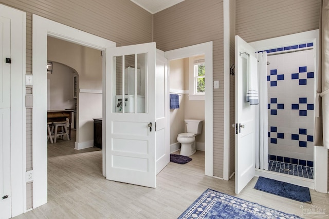 bathroom with toilet and a shower stall