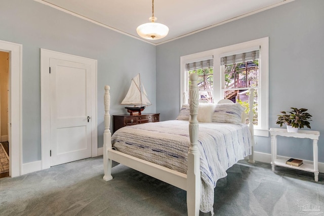 bedroom with crown molding, carpet, and baseboards