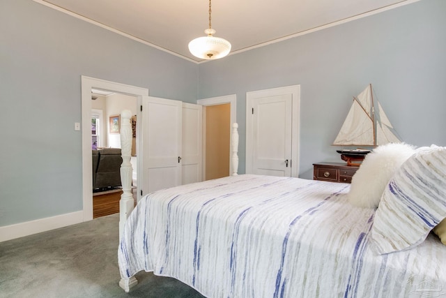 carpeted bedroom with ornamental molding and baseboards