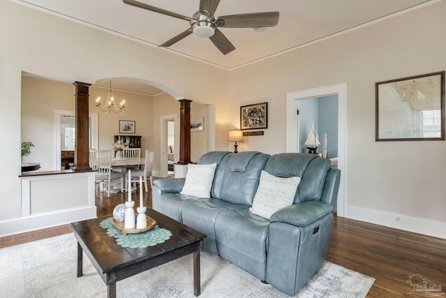 living room featuring ornate columns, wood finished floors, ceiling fan with notable chandelier, and arched walkways