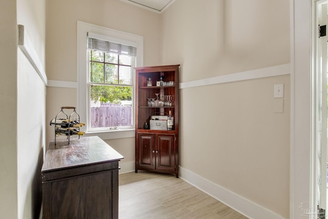 doorway featuring light wood-style flooring and baseboards