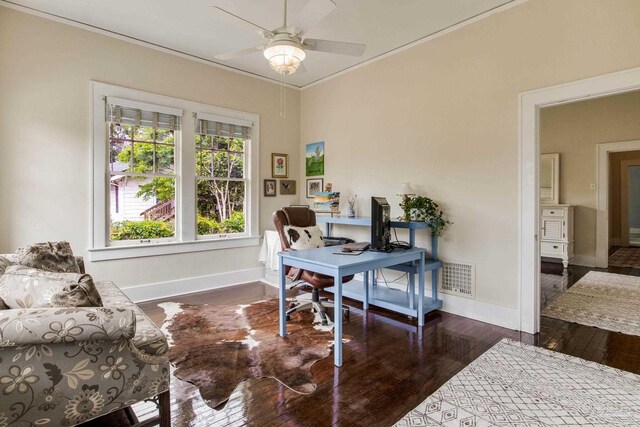 office space featuring hardwood / wood-style flooring, crown molding, visible vents, baseboards, and a ceiling fan