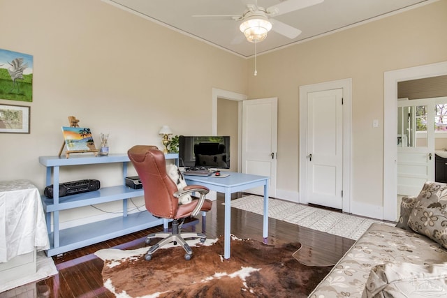 office space with crown molding, ceiling fan, wood finished floors, and baseboards