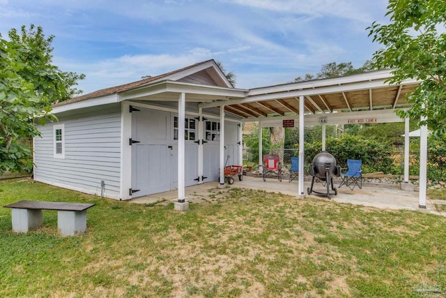 exterior space with a lawn, fence, and a patio area