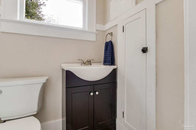 bathroom featuring toilet and vanity