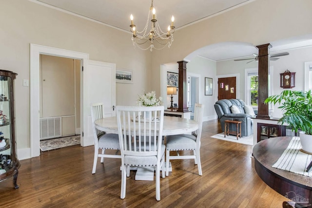 dining space featuring visible vents, arched walkways, ornate columns, and wood finished floors