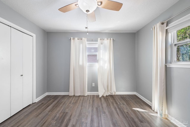 unfurnished room featuring ceiling fan, a textured ceiling, baseboards, and wood finished floors