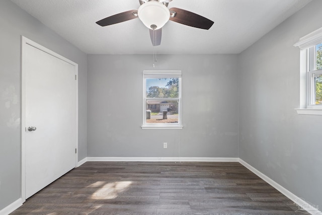 unfurnished room with baseboards and wood finished floors