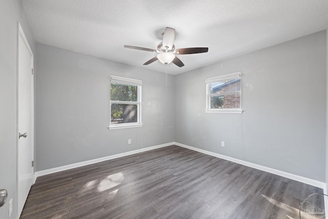 spare room featuring a textured ceiling, wood finished floors, a ceiling fan, and baseboards