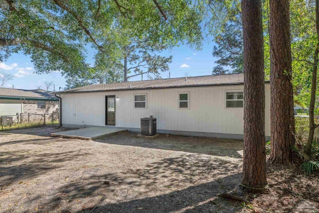 rear view of property featuring a patio area, fence, and cooling unit