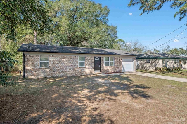 ranch-style house featuring an attached garage, driveway, and brick siding