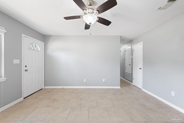 foyer with baseboards, visible vents, and a textured ceiling