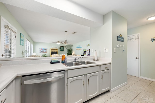 8425 Gulf Blvd Unit 213, Navarre Beach, FL 32566 - kitchen featuring stainless steel dishwasher, a sink, light countertops, light tile patterned floors, and a ceiling fan