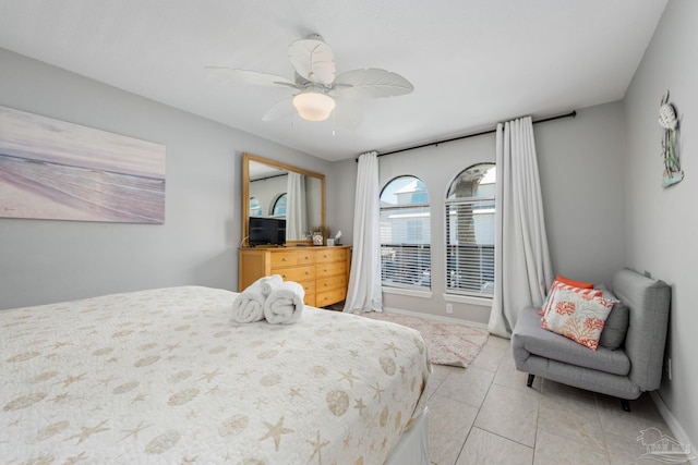 8425 Gulf Blvd Unit 213, Navarre Beach, FL 32566 - bedroom with light tile patterned floors, ceiling fan, and baseboards