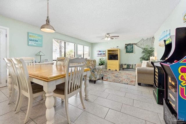 8425 Gulf Blvd Unit 213, Navarre Beach, FL 32566 - dining room with ceiling fan, a textured ceiling, and light tile patterned floors