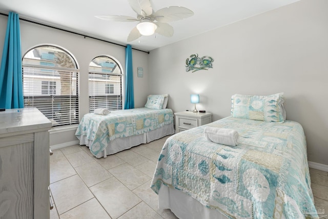 8425 Gulf Blvd Unit 213, Navarre Beach, FL 32566 - bedroom with baseboards, a ceiling fan, and light tile patterned floors