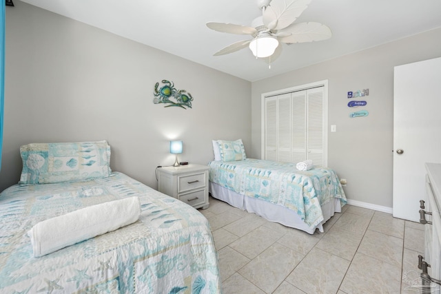 8425 Gulf Blvd Unit 213, Navarre Beach, FL 32566 - bedroom with a closet, a ceiling fan, light tile patterned floors, and baseboards
