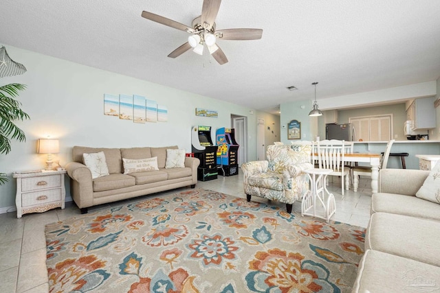 8425 Gulf Blvd Unit 213, Navarre Beach, FL 32566 - tiled living room with ceiling fan and a textured ceiling