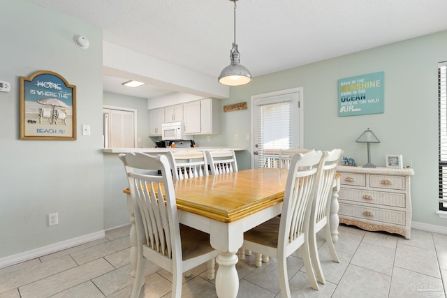 8425 Gulf Blvd Unit 213, Navarre Beach, FL 32566 - dining room with baseboards and light tile patterned flooring